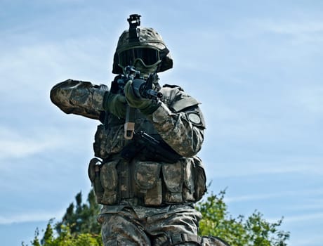 Attacking US soldier shooting his gun moving towards the camera