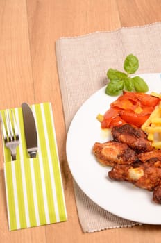 Curry chicken with tomatoes and fried potatoes
