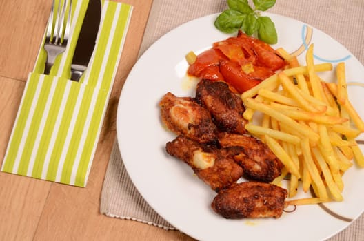 Curry chicken with tomatoes and fried potatoes