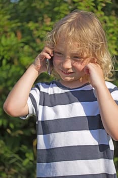 Young blond boy is calling and just think of an answer now