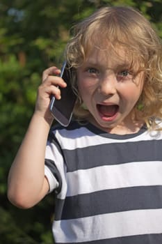 Surprised calling blond boy with opened his mouth