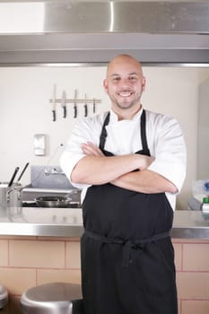 Portrait of young male chef in commercial kitchen