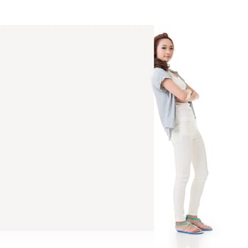 Attractive Asian woman lean on blank board of advertisement on white background.