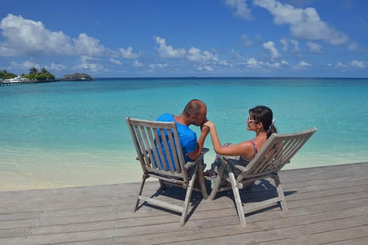 happy young couple have fun and relax at summer vacation on background maldives travel location and beautiful white sand beach