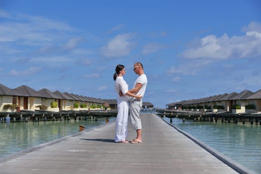 happy young couple have fun and relax at summer vacation on background maldives travel location and beautiful white sand beach