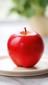 A red apple on a white plate