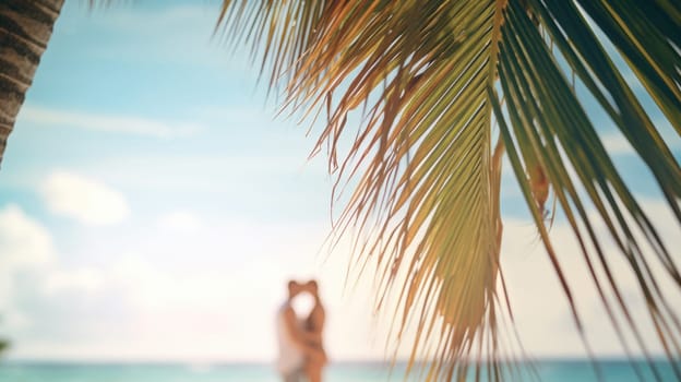 A man and woman standing under a palm tree on a beach