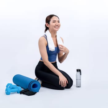 Athletic and sporty asian woman resting after intensive cardio workout training. Healthy exercising and fit body care lifestyle pursuit in studio shot isolated background. Vigorous