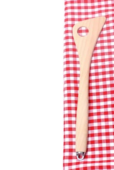 Wooden spoon on checkered fabric