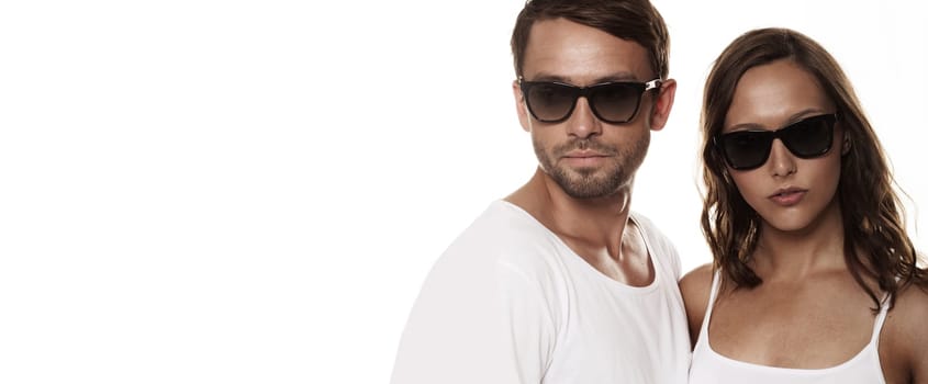 Couple wearing sunglasses isolated over a white background