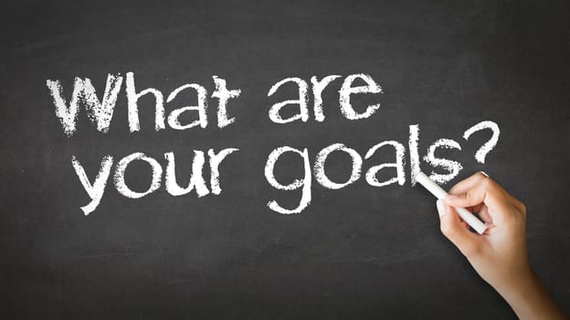 A person drawing and pointing at a What Are your Goals Chalk Illustration