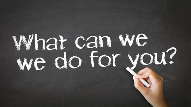 A person drawing and pointing at a What can we do for you Chalk illustration