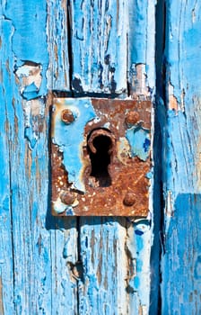 Rusted lock in weathered door ( close-up )