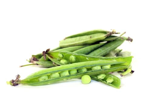 fresh green peas against a white background