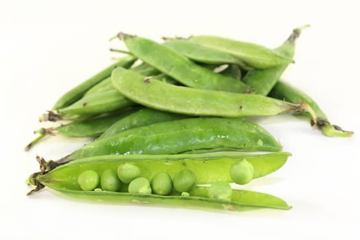 fresh green peas against a white background