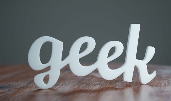 Geek sign on wooden table.