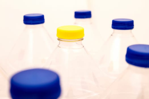 Empty bottles of mineral water, one with a different lid.