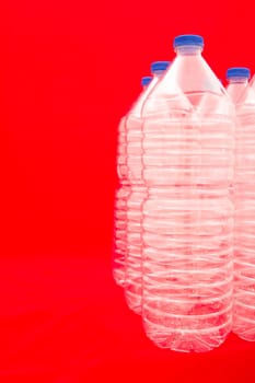 Empty bottles of mineral water with red background