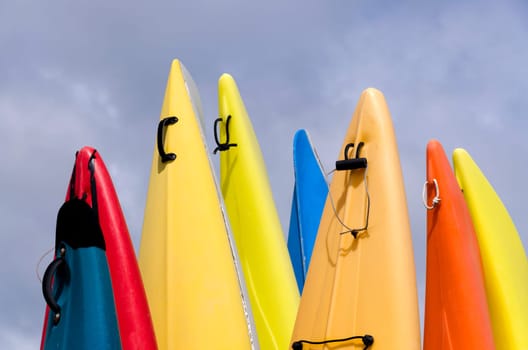 colorful canoes with cloudy sky