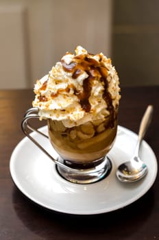 coffee with cream and caramel in glass cup