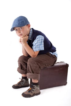 Child sitting on suitcase