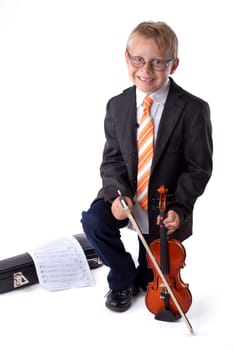 little boy enjoys playing the violin
