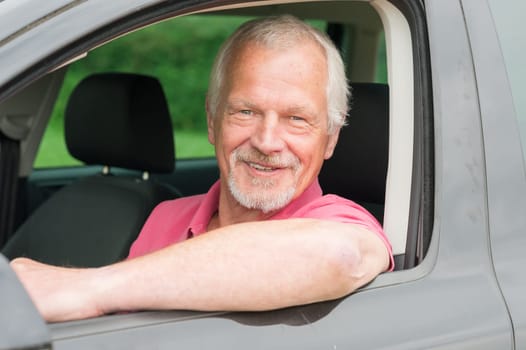 Smiling senior in a car