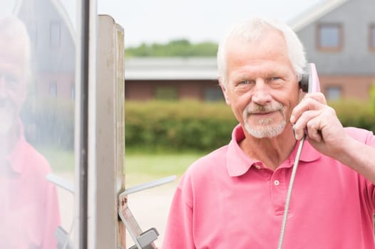 Senior at a phone booth