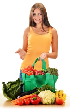 Young woman with variety of grocery products in shopping bag isolated on white