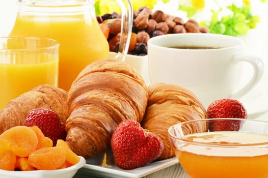 Breakfast with croissants, cup of coffee and fruits