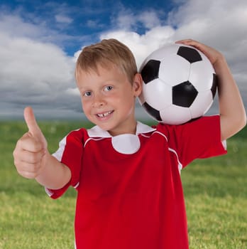 small footballer with red jersey