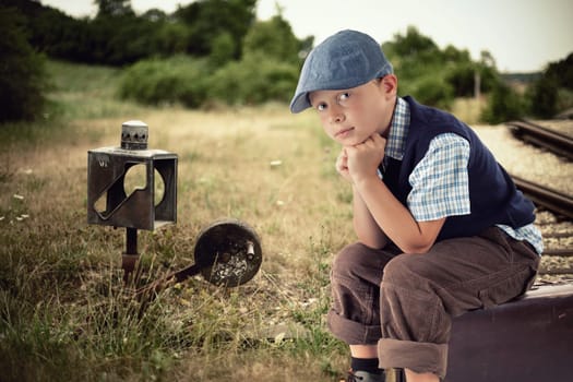 little boy waiting at the train station