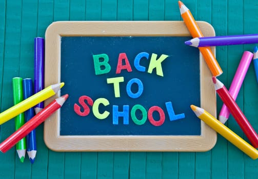 Back to school background with blackboard and coloured pencils