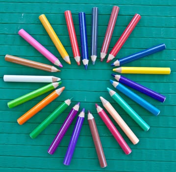 Background with a heart of colored pencils