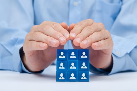 Customer care, care for employees, labor union, CRM, and life insurance concepts. Protecting gesture of businessman or personnel and glass cubes with icons representing group of people..