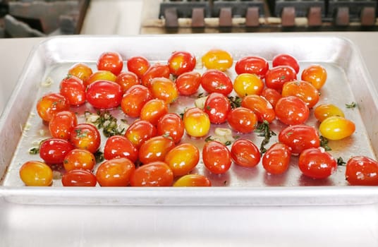 Many colorful Tomato red and yellow on a tray ready to be served with a steak