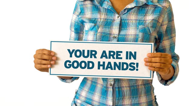 A woman holding a You are in Good hands sign.