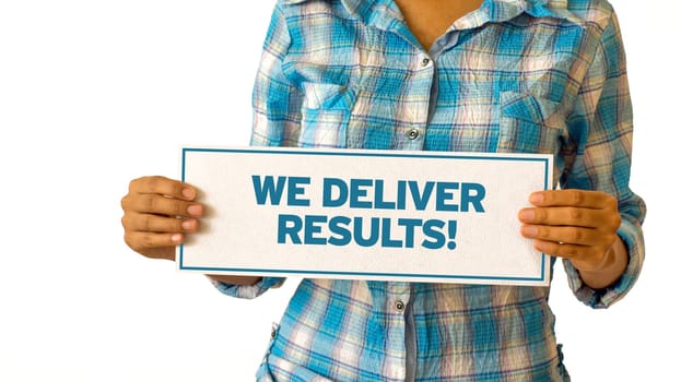 A woman holding a We Deliver Results sign.