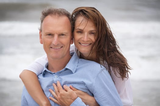 Happy adult couple couple on holiday at the beach in summer