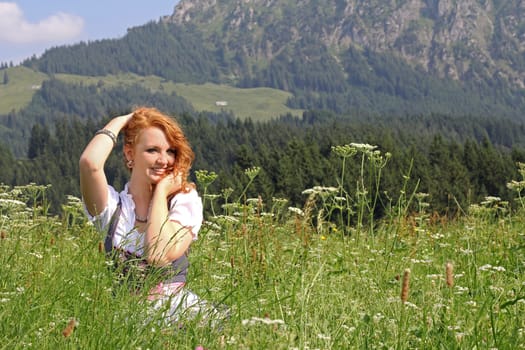 In a dirndl on the mountain meadow