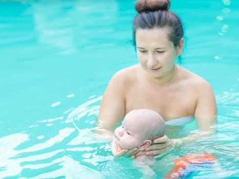 Baby and mom in swimming pool