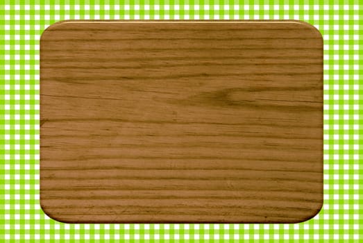 Wooden boards on green and white tablecloth