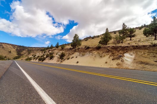 Highway passing through an arid desert in Central Oregon