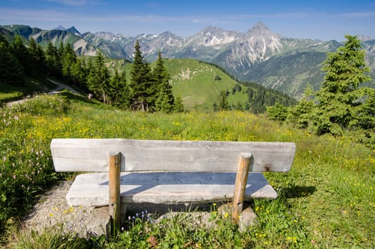 Bank in the Tannheimer Tal with a view of an alpine pasture and mountains
