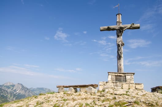 Wooden summit cross in Tyrol Austria on the Neunerköpfle in the Tannheimer Tal