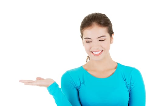 happy,excited young woman presenting copy space on her palm,isolated on white
