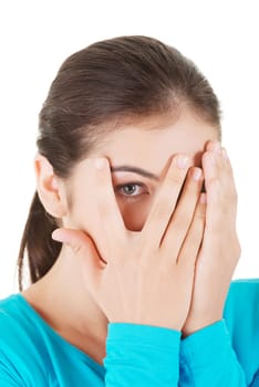 shy teenage girl peeking through covered face,isolated on white.