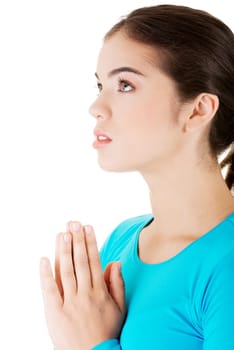 young pretty caucasian girl praying over white background.
