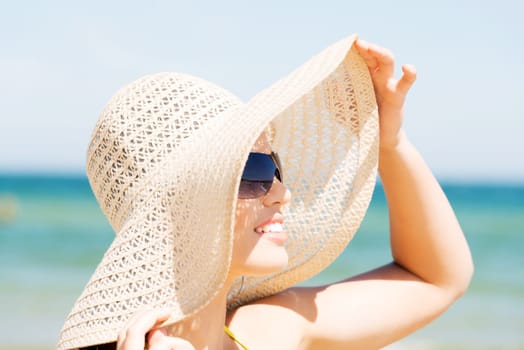 beautiful woman on a beach. coastline in sunglasses.