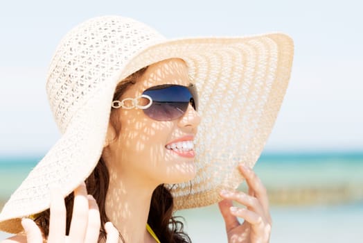 beautiful woman on a beach. coastline in sunglasses.